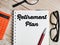 Top view text Retirement Plan written on note book