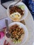 Top view Thai food Stir fried pork with basil chili with rice in an Asian dish.