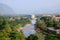 The top view at Tham chang cave can see tourists walking across the orange suspension bridge over the Song River, Vang Vieng Laos.