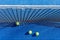 top view of three balls on a blue paddle tennis court