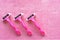 Top view of three disposable pink shaving razors