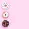 Top view of three donuts different kinds isolated on pink background, copy space