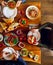 Top view of three people having dinner together while sitting at the wooden table, with variety of Turkish snacks