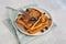 Top view of three slices of french toast with blueberries and a fork on a plate on grey background, minimalistic style with copy