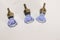 Top view of three very small blue glass drawer knobs or pulls