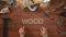 Top view time-lapse of a hand laying on wodden table word `WOOD`