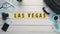 Top view time lapse hands laying on white desk word `LAS VEGAS` decorated with travel items