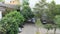 Top view TimeLapse of busy car park with green trees in business city