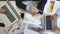 Top view to hands of business people working efficiently using laptops and graphs. Group of workers sitting at table in