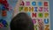 Top view of a toddler boy playing alphabet puzzle to learning English