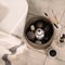 Top view of toiletries in  basket and toothbrushes on the floor