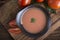 Top view tomato soup in bowl on cutting board