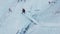 Top view of a tourist crossing a frozen stream over a bridge in winter.