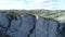 Top view of tourists over mountain abyss. Shot. Fascinating view of rock cliff and panorama of green vegetation. Group