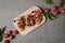 top view of traditional italian bruschetta on wooden board with basil and fresh tomatoes on grey