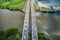 Top view on traffic on the straight bridge over water. Parallel separate roads