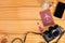 Top view of travel essential equipment on wooden table. Passport and padlock locked on miniature toy suitcase, camera and mobile