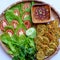 Top view tray of Vietnamese vegan food, green bean pies with salad