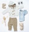 Top view trendy look of baby boy clothes with toy in countryside