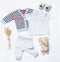 Top view trendy look of baby boy clothes with toy and sneakers