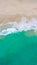 Top view at a tropical beach with waves and blue ocean Drone aerial view at Freedom beach in Phuket