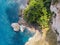 Top view of tropical island forest and emerald clear water in bali