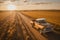 A top view of a truck on a lush crop field, symbolizing the role of transportation in the agricultural industry