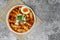 Top view Tteokbokki Spicy Rice Cakes with boiled eggs and cheese on the grey concrete table, Korean street food