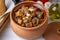 Top view of Turkish dish Guvech - baked meat with eggplant and traditionally served in earthenware pot (Turkish name etli