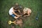 Top view of two brothers sitting on  grass playing with mud