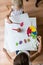 Top view of two children painting with watercolors with brush an