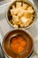 top view of two metal bowls with eggs and sliced butter