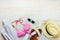 Top view of two pieces pink swimming suit and beach accessoties over wooden background. Copy space=