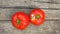 Top view. Two Spoiled Organic Ripe Red Tomatoes with Black Spots on Wood Texture Background. Tomato Diseases.