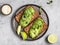 Top view on two toasts with avocado on a table