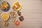 Top view of typical June Party foods on a wooden table: Popcorn, cornmeal cake, corn kernels, peanut pods, peanuts candies paÃ§