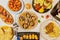 top view of typical Spanish food dishes with real empanada, scallops, Galician octopus, escalope, croquettes and Spanish potato