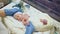 Top view of unrecognizable doctor examining premature baby with stethoscope at neonatal intensive care unit in hospital