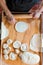 Top View of Unrecognizable Hispanic Woman Kneading Dough with Hands and Rolling Pin in Her Countryside Kitchen