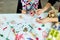 Top view unrecognizable mother and her daughter in easter holiday coloring easter eggs