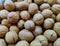 Top view unshelled browned walnuts on the counter of a farmers market