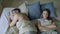 Top view of upset lying sleepless couple in bed offended because of quarrel