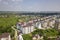 Top view of urban developing city landscape with tall apartment buildings and suburb houses. Drone aerial photography