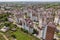 Top view of urban developing city landscape with tall apartment buildings and suburb houses. Drone aerial photography