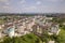 Top view of urban developing city landscape with tall apartment buildings and suburb houses. Drone aerial photography