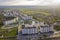 Top view of urban developing city landscape with tall apartment buildings and suburb houses. Drone aerial photography