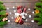 Top view of utensils on festive napkin on wooden background. Christmas decorations with dried fruits and cinnamon. Close up of New