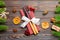 Top view of utensils on festive napkin on wooden background. Christmas decorations with dried fruits and cinnamon. Close up of New