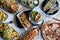 Top view of a variety of freshly-prepared dishes arranged on multiple plates.