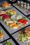 Top view of variety of Japanese dishes on dark background. Vertical image